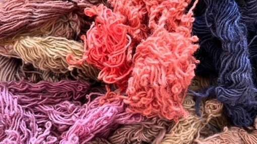 Mira's died yarn, a mix of coral and pink and purples