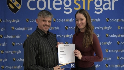 a tutor presenting a student with certificate
