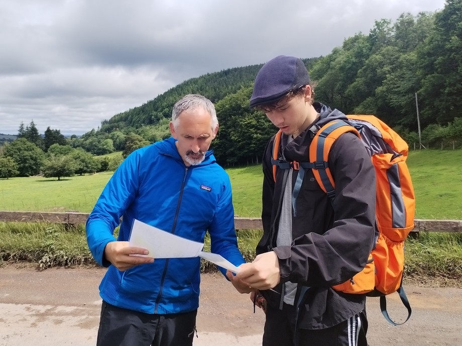 Lecturer Steve Bird helping a student with navigation and a map