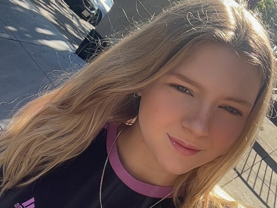 A selfie of Amber wearing a black t-shirt and she has long fair hair