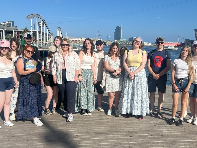 The group pictured in a scenic harbour