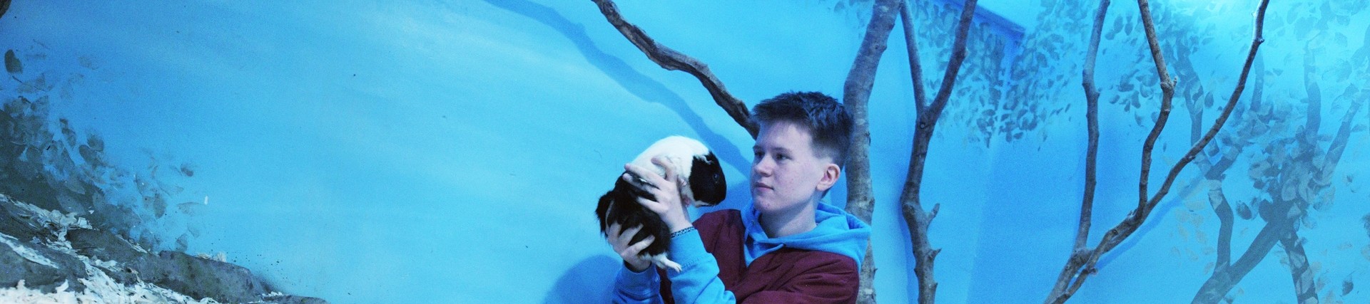 A student holding a Guinea pig.