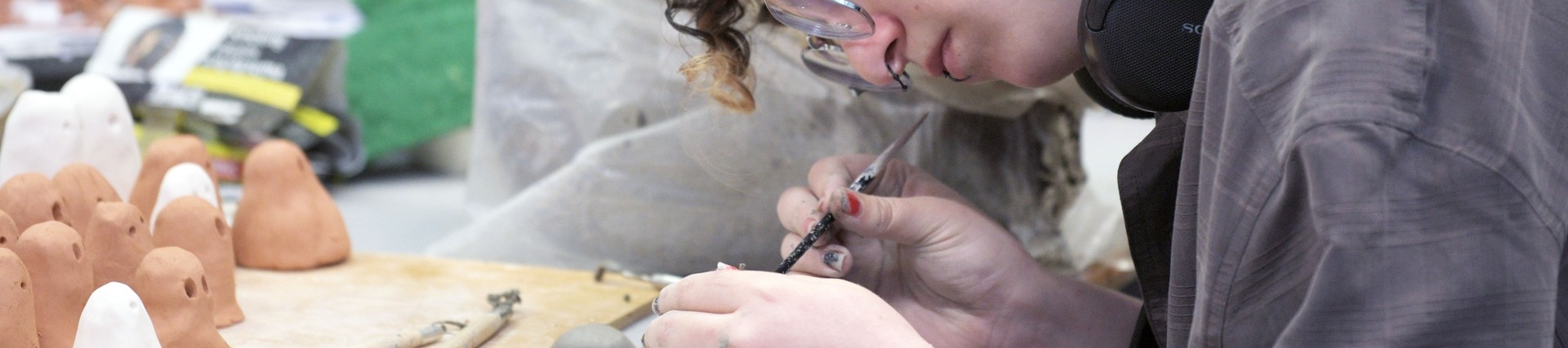 A student works on sculptures. 