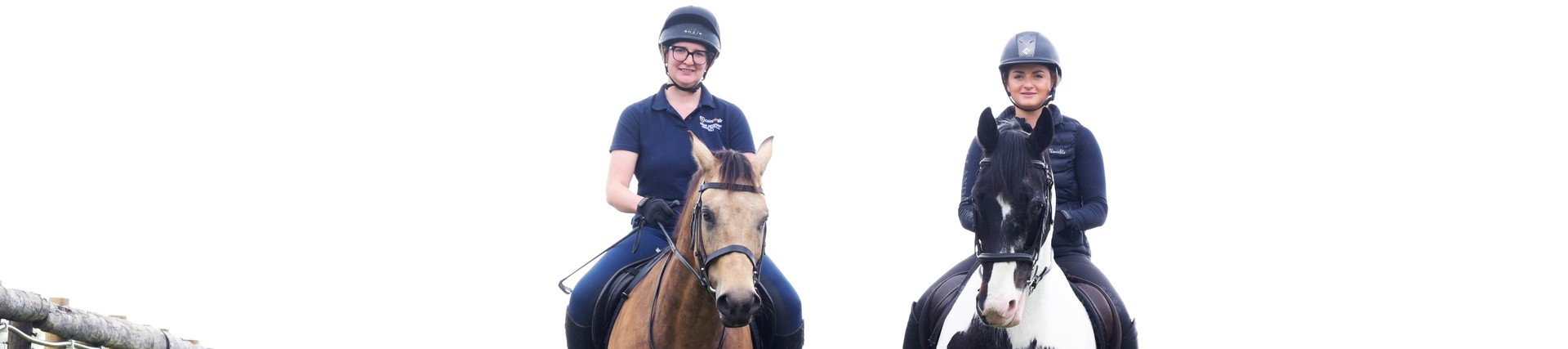 Two students riding horses.