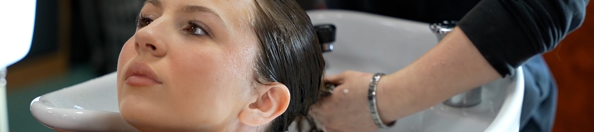 A student washes hair.