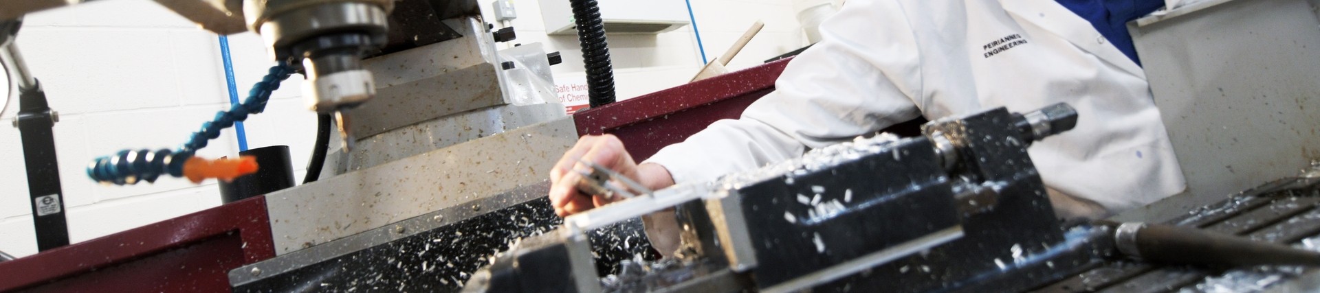 A lecturer using a mechanical cutting machine.