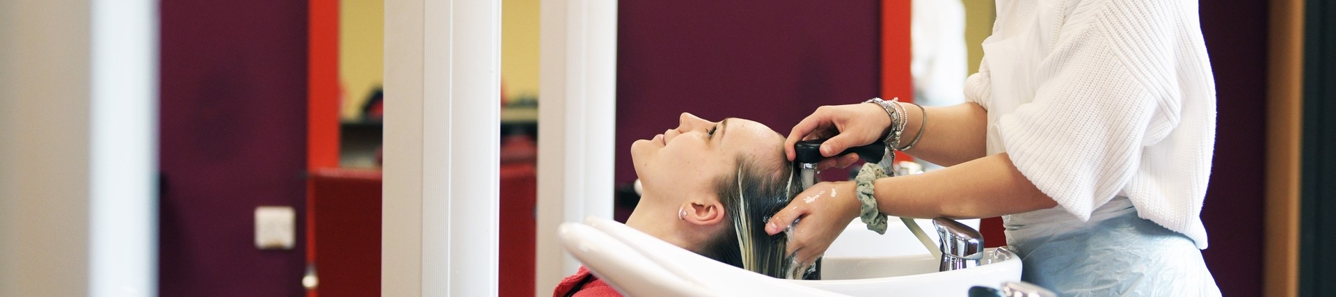 A student washing hair.