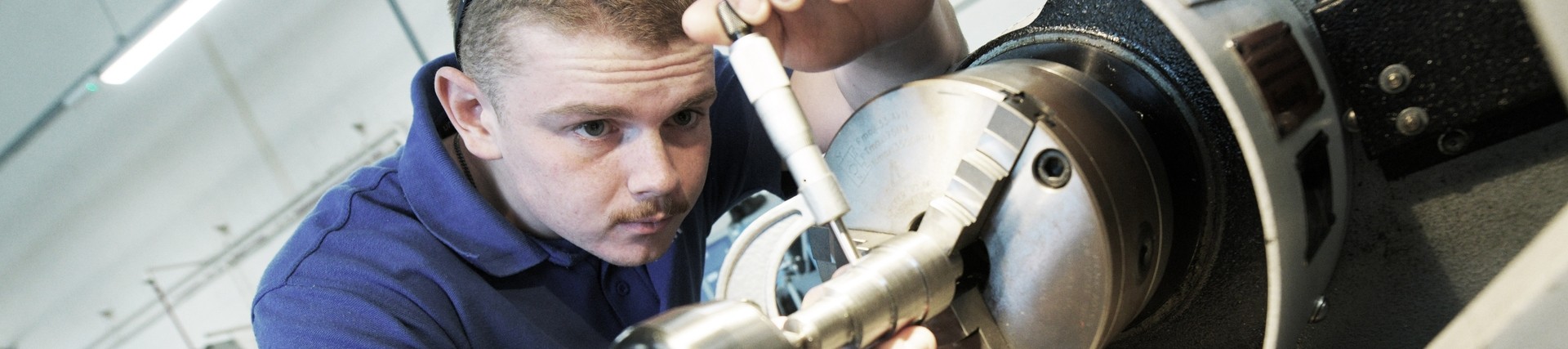 A student using a lathe. 