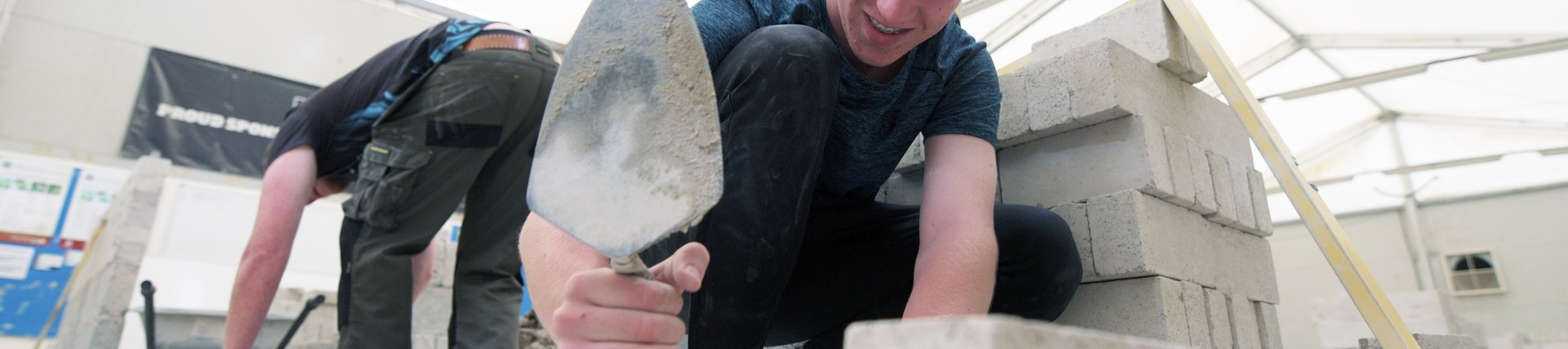 A student learning bricklaying. 