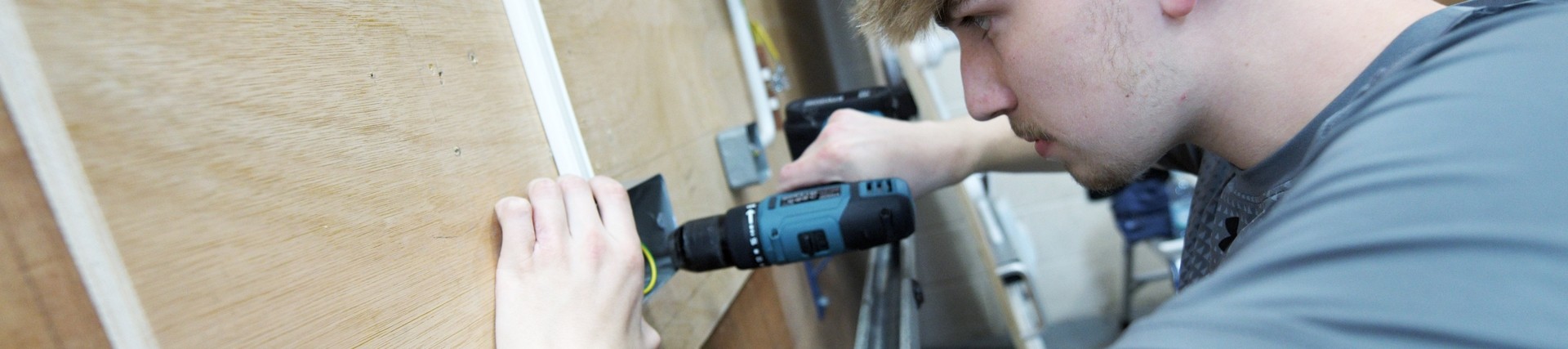 A student using a drill.