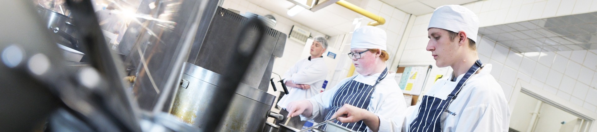 Students working hard in the kitchen.