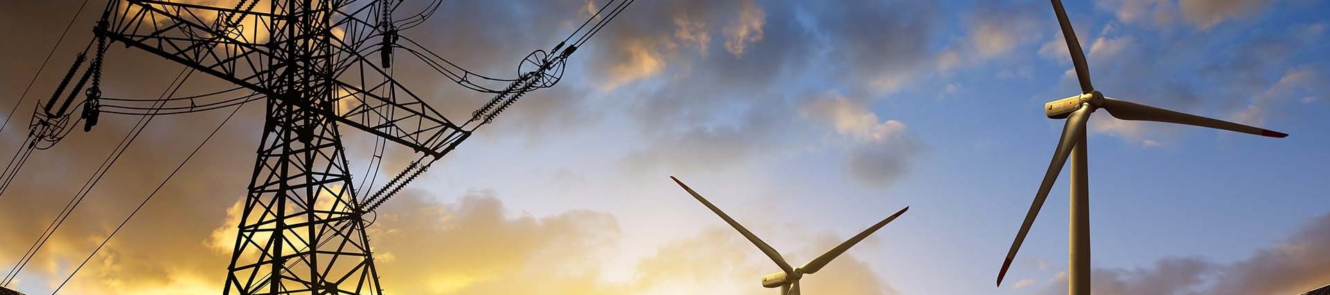 Solar panels and wind turbines during sunrise