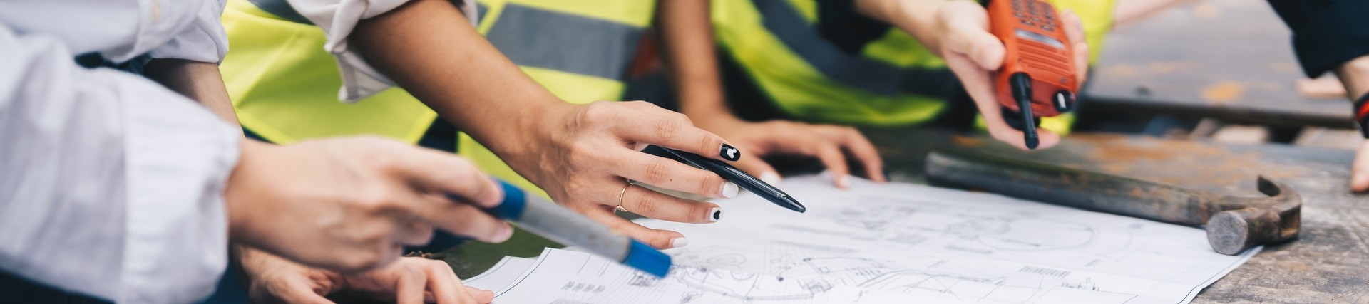 Construction workers looking over paper