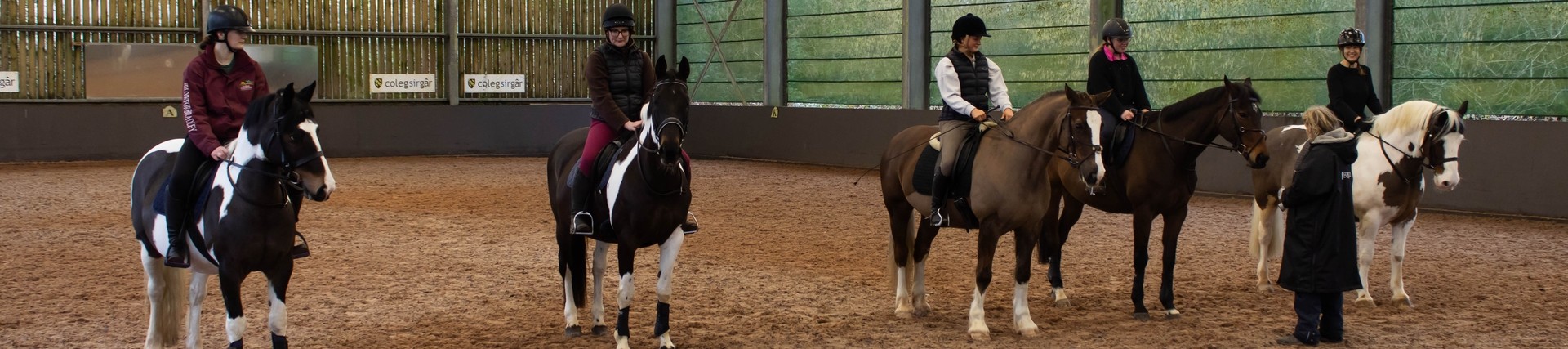 five female students on horses 