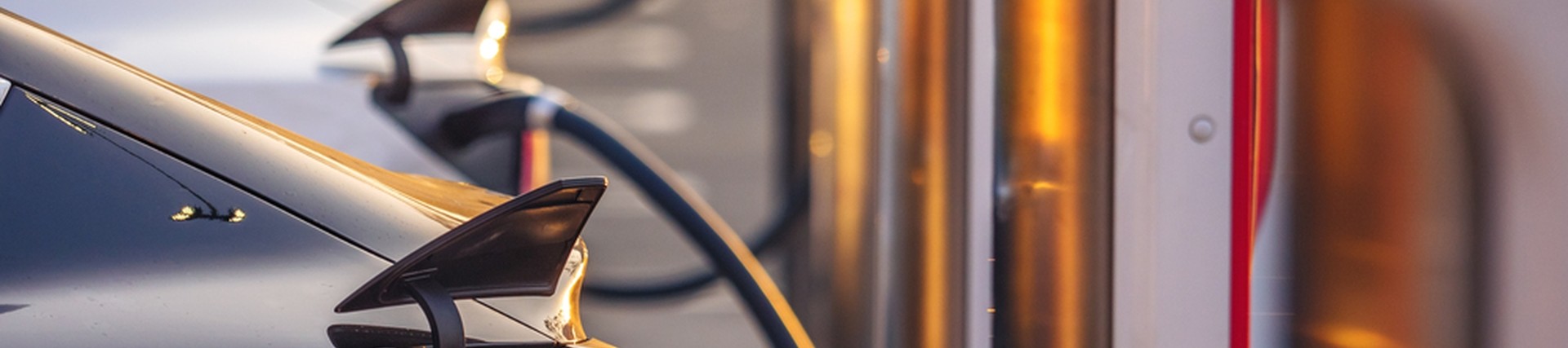 Close-up shot of Electrical Vehicles being charged with an Electrical Vehicle Charging point