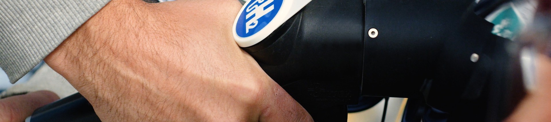 Up close shot of someone fueling a Hydrogen powered vehicle