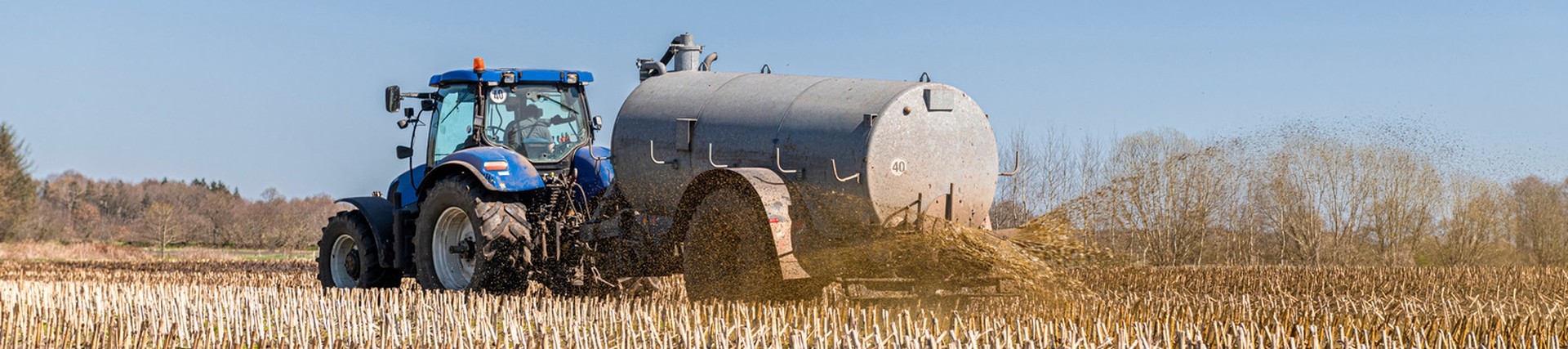 Tractor spraying slurry on a field