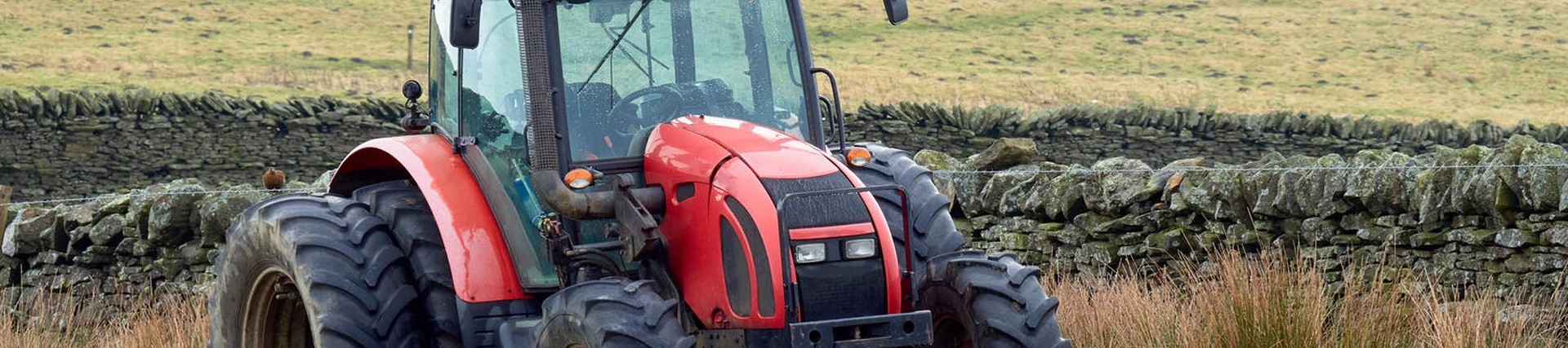 Red tractor driving in a field