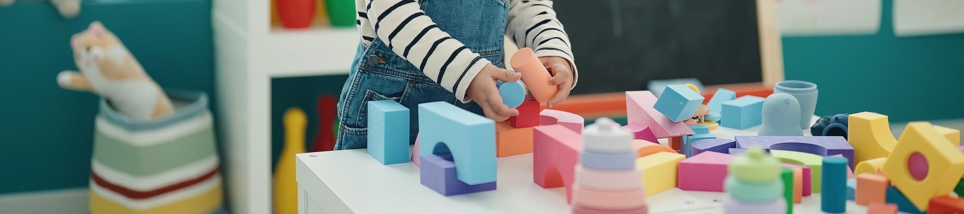 boy playing with construction blocks in kindergarten