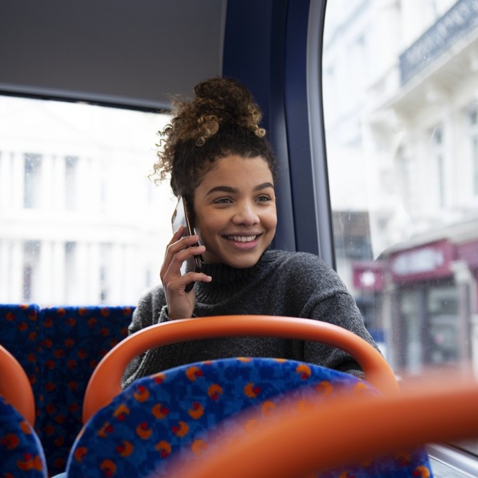 Student on their phone on the bus.