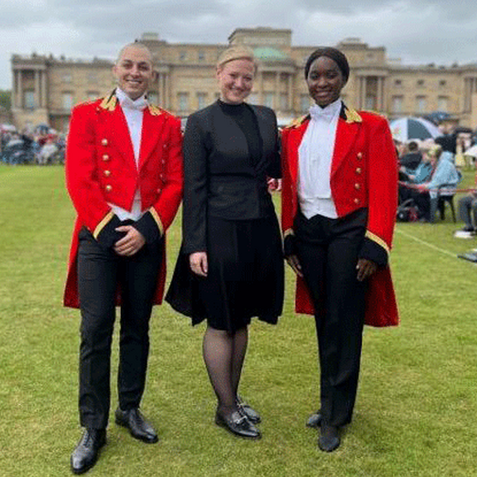 Workers at Buckingham Palace in red official and royal attire